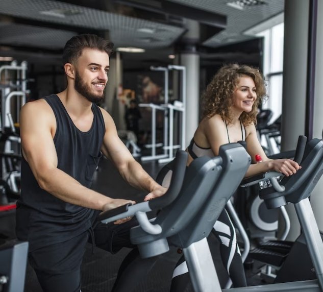 young woman and her trainer running on treadmill in gym